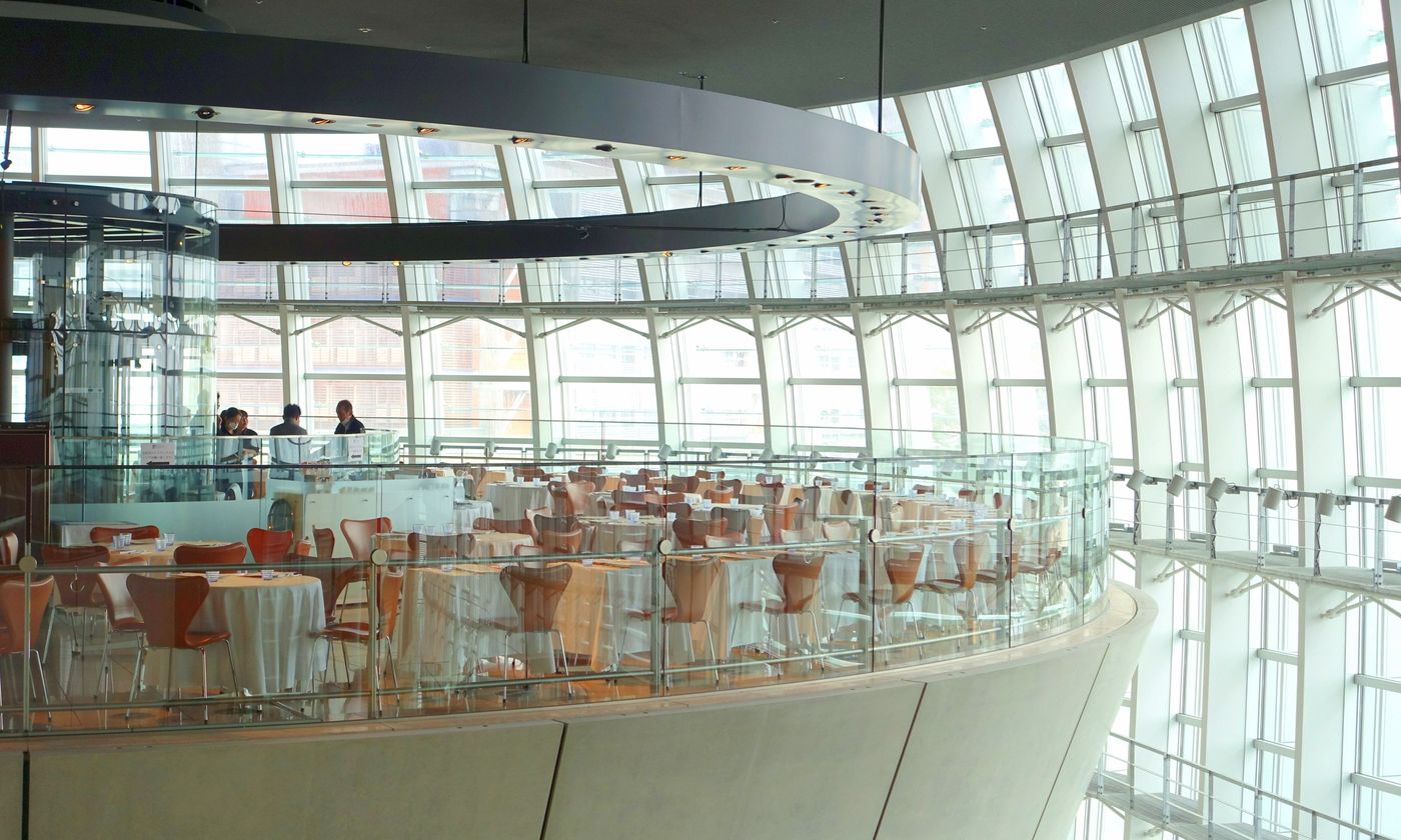 The glass-walled interior atrium of the National Art Center, Tokyo