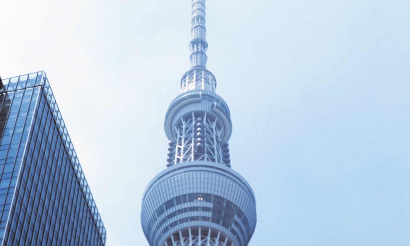 Tokyo Skytree seen from street level against a pale sky